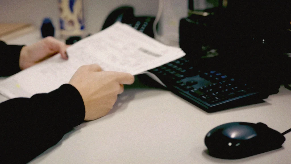 Profissional utilizando sistema em computador para emissão de notas fiscais eletrônicas, representando a automação de NFe, NFCe e NFSe com o sistema da Target.